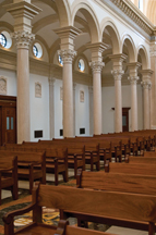 The arches in Our Lady of the Most Holy Trinity Chapel are supported by 14-foot, Botticino marble columns. Their Corinthian capitals are adorned with acanthus leaves and doves, symbolizing the Holy Spirit. Courtesy of Thomas Aquinas College